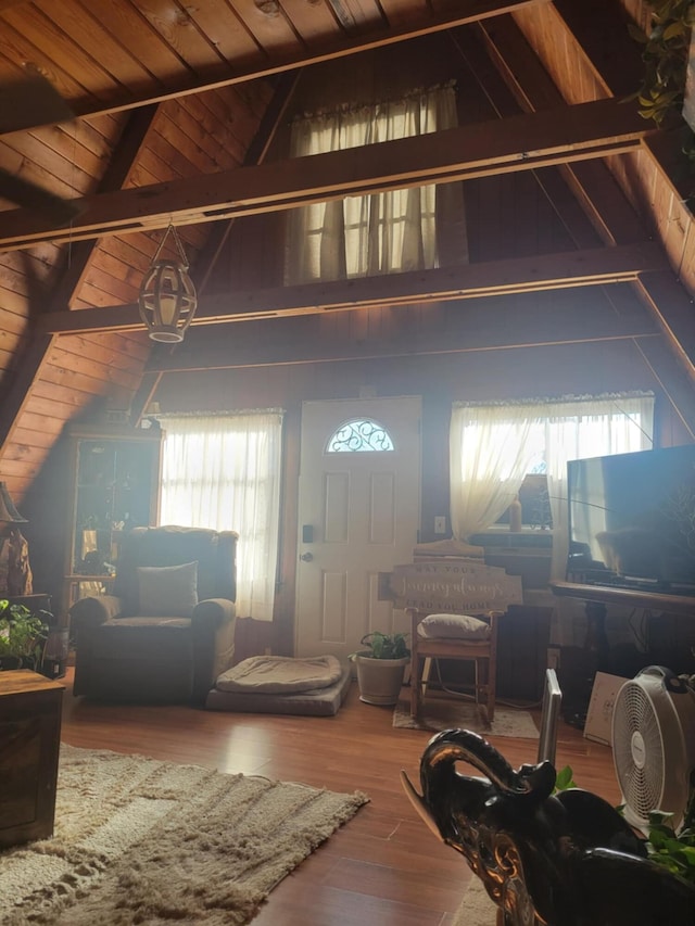 living room with a healthy amount of sunlight, lofted ceiling with beams, and wooden ceiling