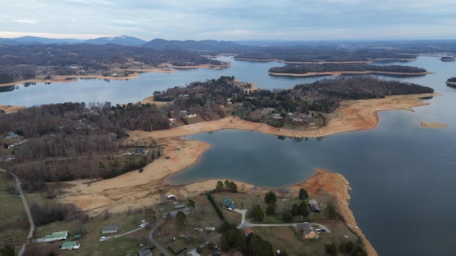 drone / aerial view featuring a water and mountain view