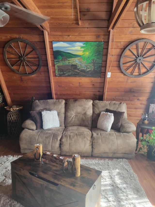 living room with wood-type flooring and wood walls