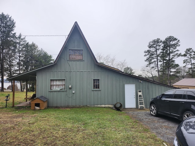 view of home's exterior with a carport and a lawn