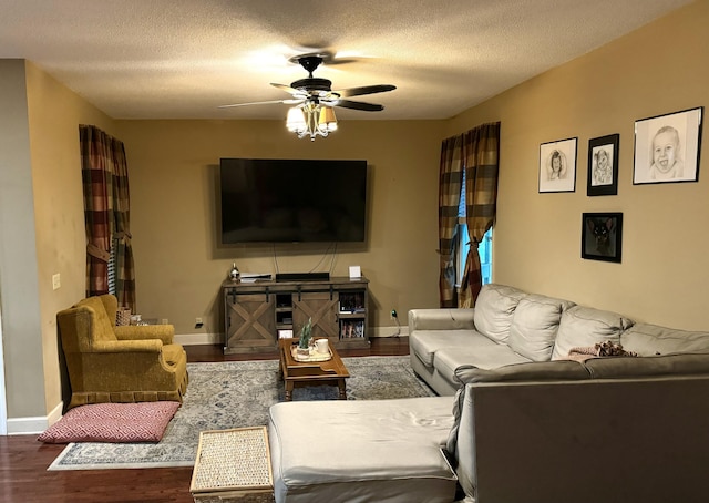 living area with a ceiling fan, a textured ceiling, baseboards, and wood finished floors