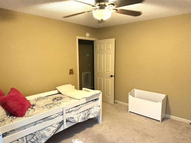 bedroom featuring baseboards, visible vents, a textured ceiling, and light colored carpet