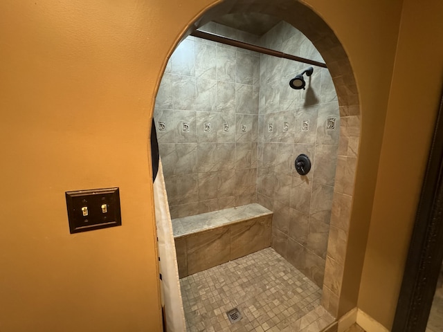 bathroom with tiled shower