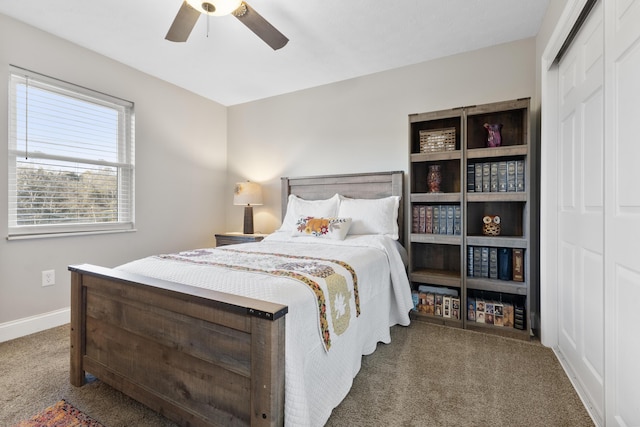 carpeted bedroom with ceiling fan and a closet