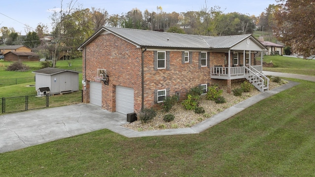 exterior space featuring a garage, a storage shed, and a lawn