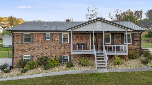 view of front of home with a porch and a front yard