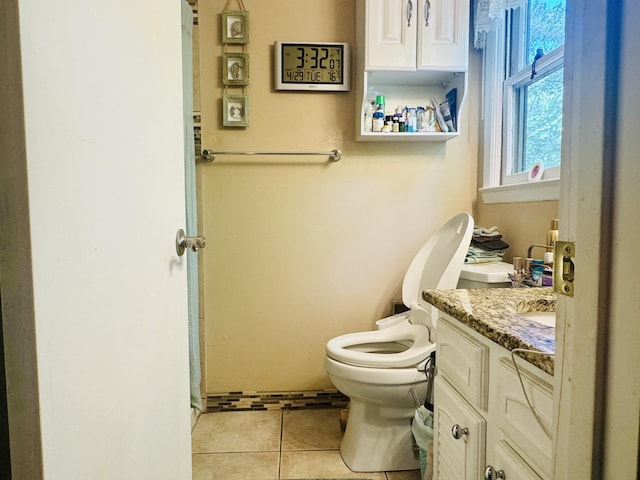 bathroom featuring tile patterned flooring, toilet, and vanity