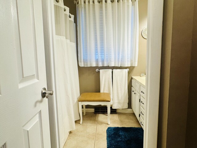 bathroom with tile patterned flooring and vanity