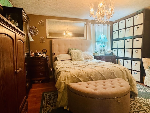 bedroom featuring a textured ceiling, a chandelier, and wood finished floors