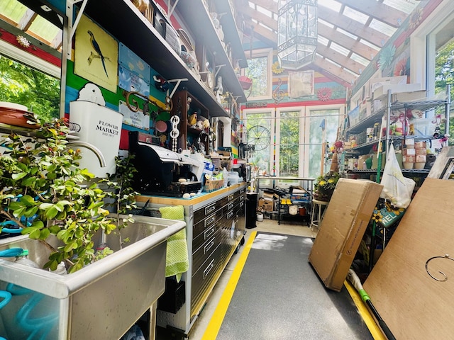 miscellaneous room with a high ceiling and a workshop area