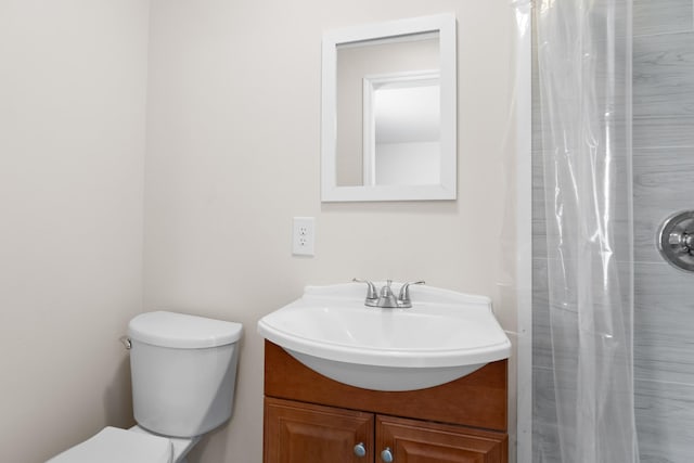 bathroom featuring vanity, toilet, and a shower with curtain