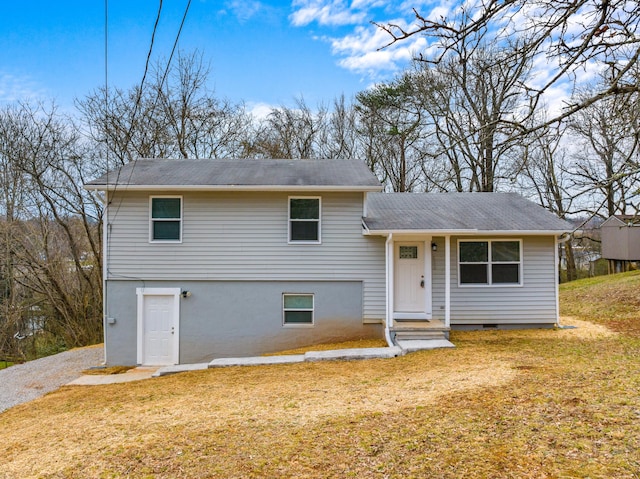 tri-level home with a front lawn