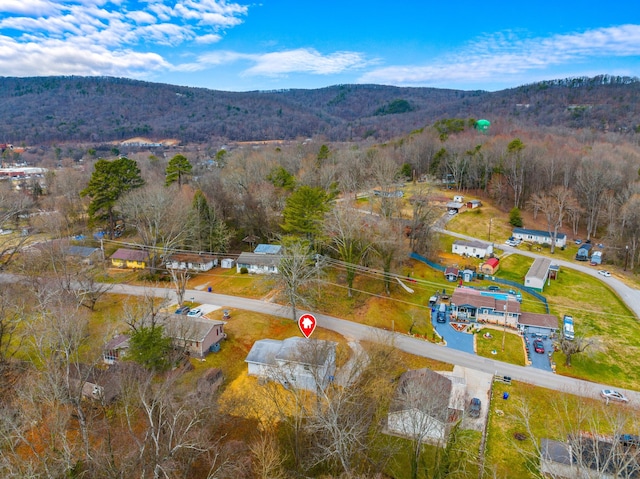 aerial view featuring a forest view and a mountain view