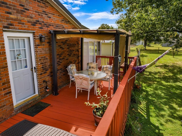 wooden terrace featuring a lawn