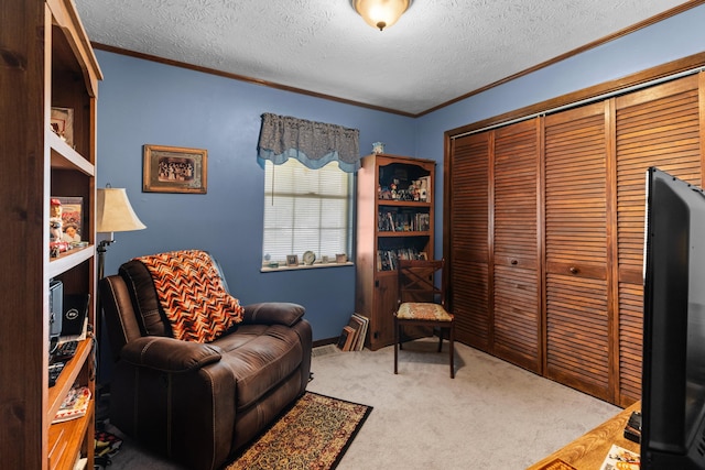 sitting room featuring a textured ceiling, carpet flooring, and ornamental molding