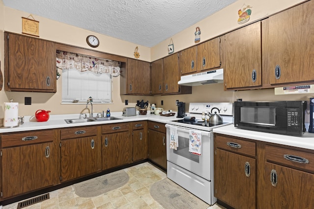 kitchen with white range with electric cooktop, sink, and a textured ceiling