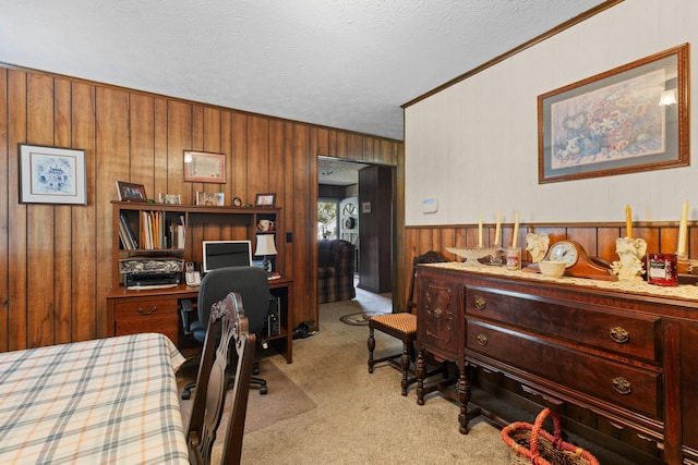 office with light carpet, wood walls, a textured ceiling, and ornamental molding