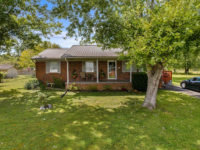 single story home with covered porch and a front lawn