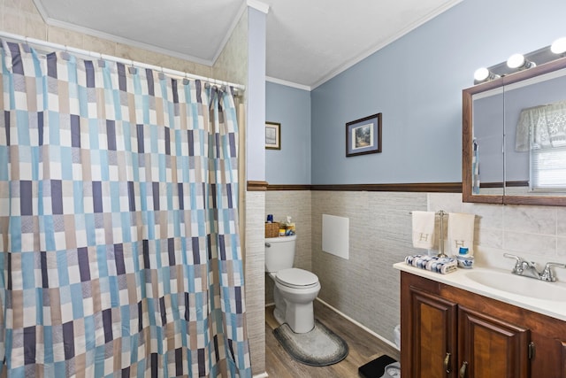 bathroom featuring toilet, hardwood / wood-style flooring, tile walls, crown molding, and vanity