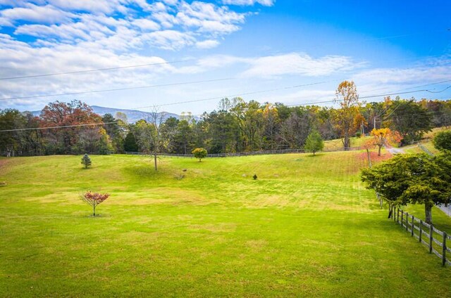 view of community featuring a yard and a rural view