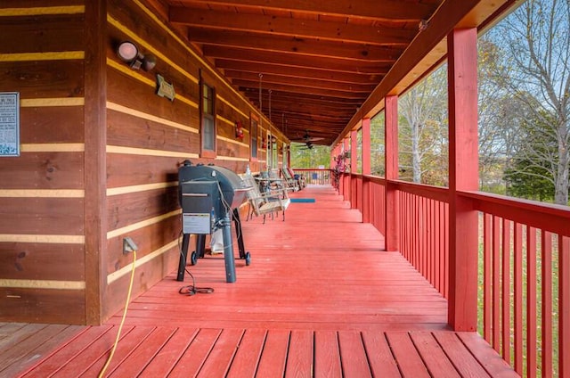 wooden deck with a grill and a porch