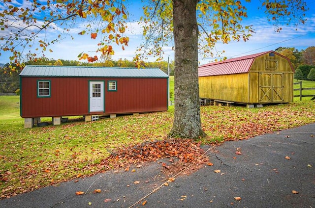 view of side of property featuring a storage unit