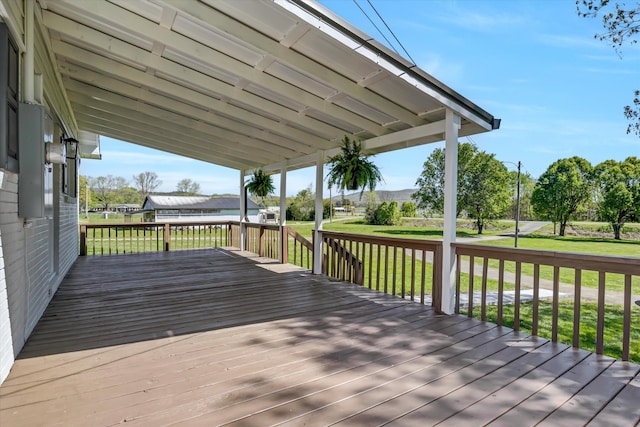 wooden deck featuring a lawn
