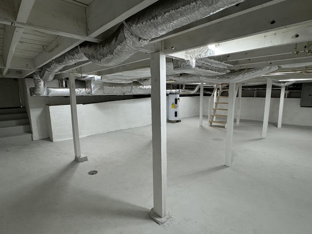 basement featuring electric panel and water heater