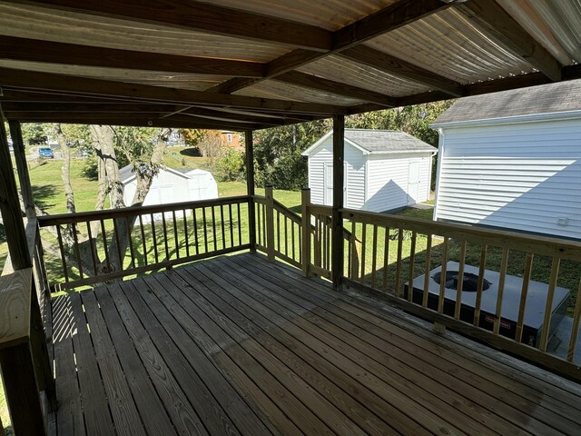 deck with a yard and a shed