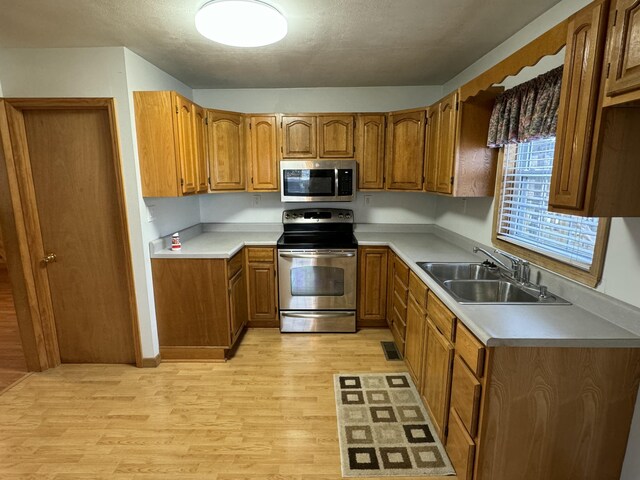 kitchen featuring light hardwood / wood-style floors, sink, and stainless steel appliances