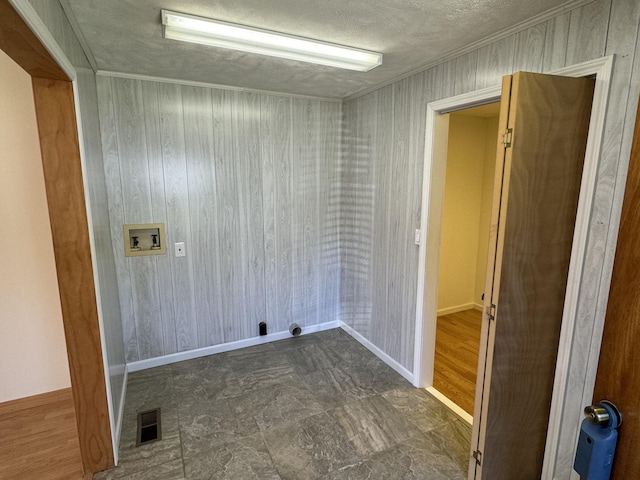 laundry room featuring washer hookup and a textured ceiling