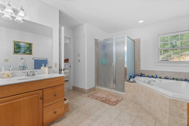 bathroom with tile patterned floors, vanity, and separate shower and tub