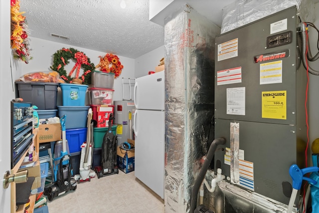 utility room featuring heating unit and water heater