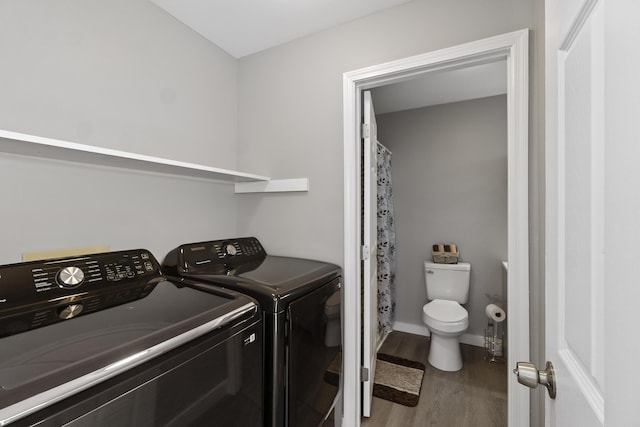 laundry room featuring washer and clothes dryer and wood-type flooring