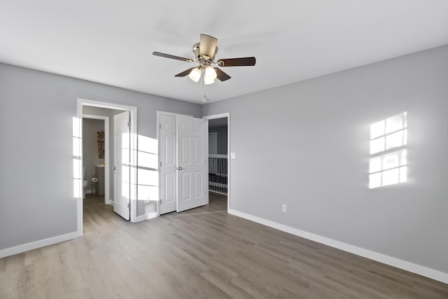 unfurnished bedroom featuring hardwood / wood-style floors and ceiling fan