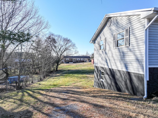 view of side of home featuring a lawn