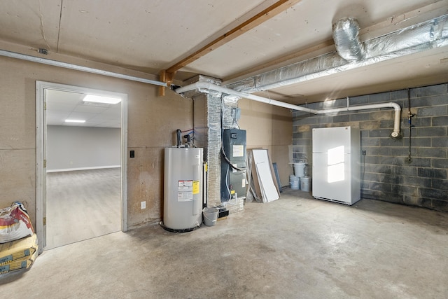 basement featuring water heater, white fridge, and heating unit