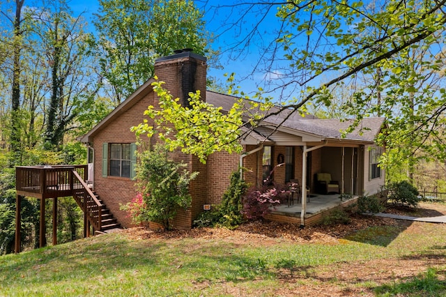 961 Woodway Dr, Morristown, TN 37814 - back of property with a deck, a patio area, a chimney, stairs, and brick siding