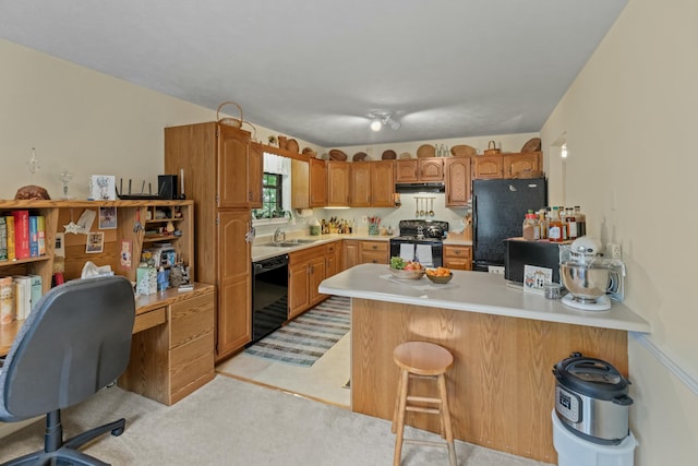 961 Woodway Dr, Morristown, TN 37814 - kitchen featuring a breakfast bar, a peninsula, light countertops, under cabinet range hood, and black appliances
