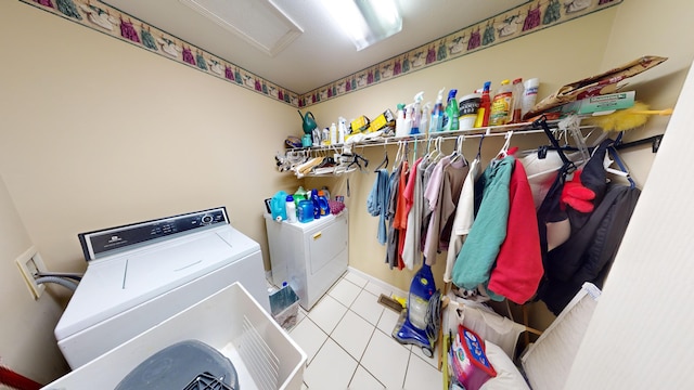 clothes washing area featuring light tile patterned floors and independent washer and dryer