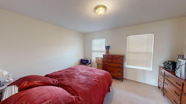 carpeted bedroom featuring a textured ceiling