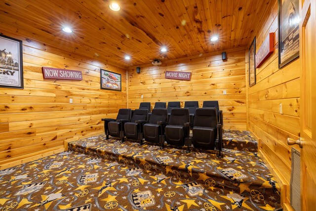 carpeted cinema featuring wooden ceiling and wooden walls