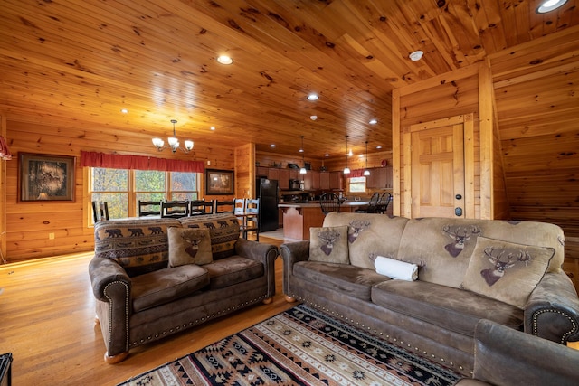 living room with wood ceiling, light hardwood / wood-style flooring, wooden walls, and a chandelier