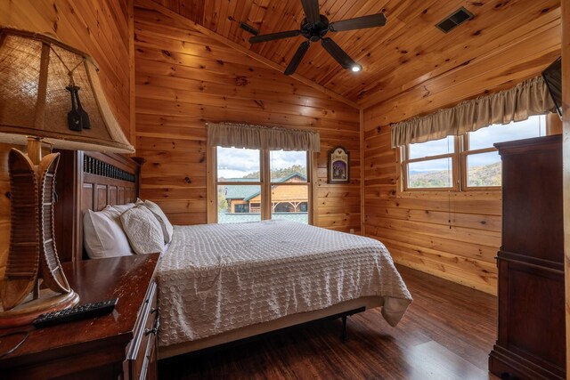 bedroom featuring wood ceiling, vaulted ceiling, ceiling fan, wooden walls, and dark hardwood / wood-style floors