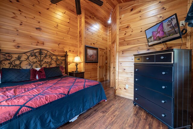 bedroom featuring dark hardwood / wood-style floors, ceiling fan, wooden ceiling, and wooden walls