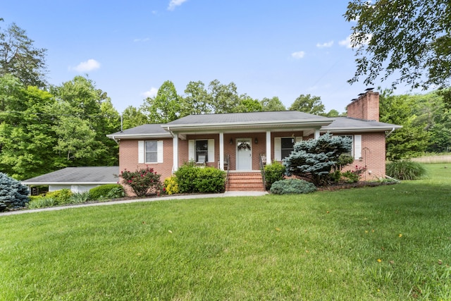 10741 Rutledge Pike, Blaine, TN 37709 - view of front facade featuring brick siding, a front yard, a chimney, and covered porch