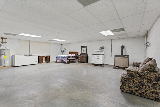 10741 Rutledge Pike, Blaine, TN 37709 - garage featuring water heater, concrete block wall, a wood stove, and fridge