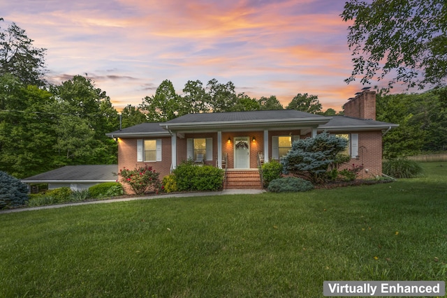 10741 Rutledge Pike, Blaine, TN 37709 - view of front facade with brick siding, a chimney, a porch, and a yard