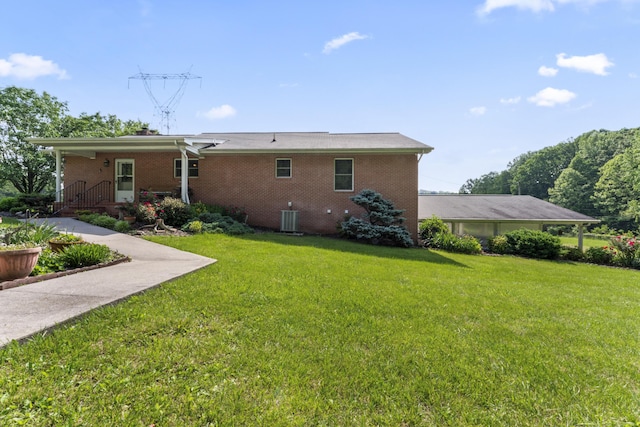 10741 Rutledge Pike, Blaine, TN 37709 - rear view of house with brick siding, a yard, and central AC unit