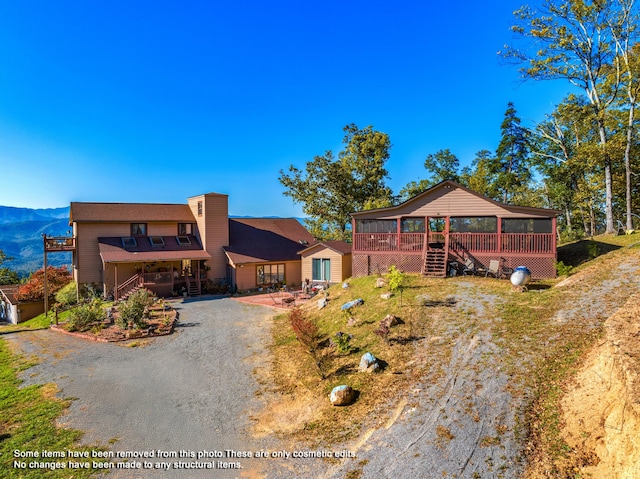 view of front of house featuring a mountain view and a sunroom